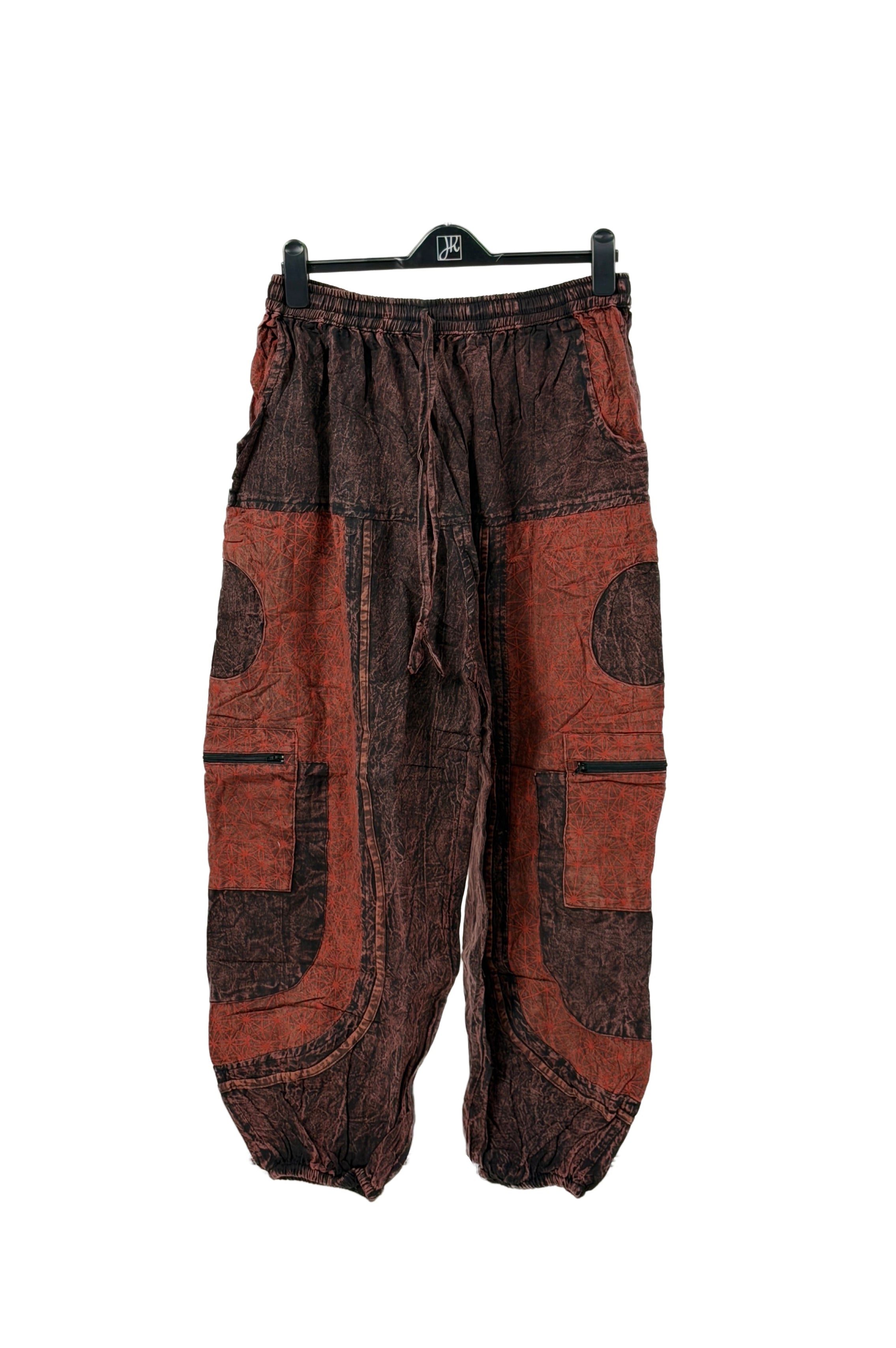 Pair of brown and black baggy pants on a white background